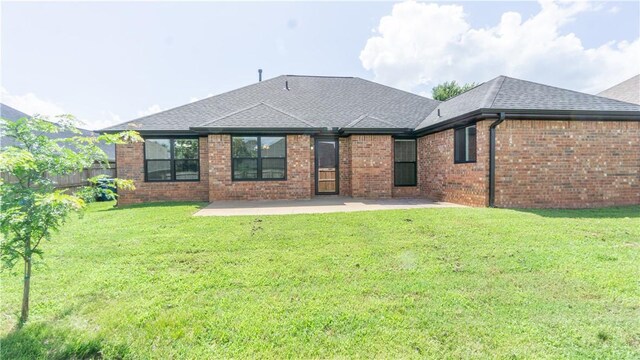 404 NE Whitney St, Bentonville, AR 72712 - rear view of house featuring roof with shingles, a patio area, and brick siding