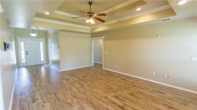 404 NE Whitney St, Bentonville, AR 72712 - spare room with a raised ceiling, ornamental molding, a ceiling fan, light wood-style floors, and recessed lighting