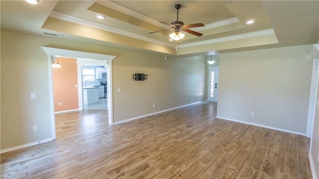404 NE Whitney St, Bentonville, AR 72712 - spare room with a tray ceiling, ornamental molding, a ceiling fan, light wood finished floors, and recessed lighting
