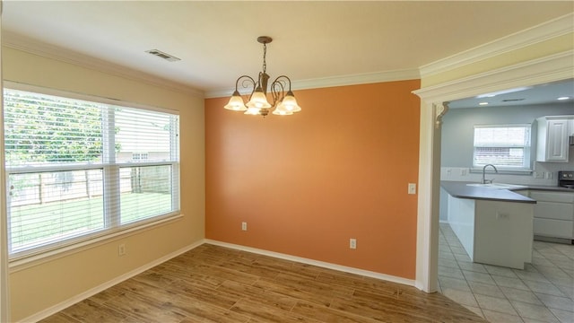 404 NE Whitney St, Bentonville, AR 72712 - unfurnished dining area with a chandelier, ornamental molding, and light wood-style floors