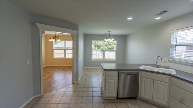 404 NE Whitney St, Bentonville, AR 72712 - kitchen featuring stainless steel dishwasher, a chandelier, light tile patterned floors, white cabinets, and recessed lighting