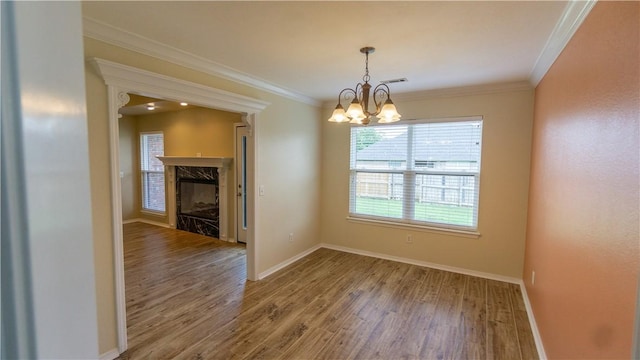 404 NE Whitney St, Bentonville, AR 72712 - unfurnished dining area featuring a chandelier, wood finished floors, ornamental molding, and a premium fireplace