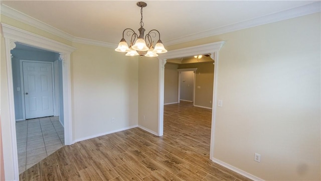 404 NE Whitney St, Bentonville, AR 72712 - spare room featuring a chandelier, wood finished floors, and ornamental molding