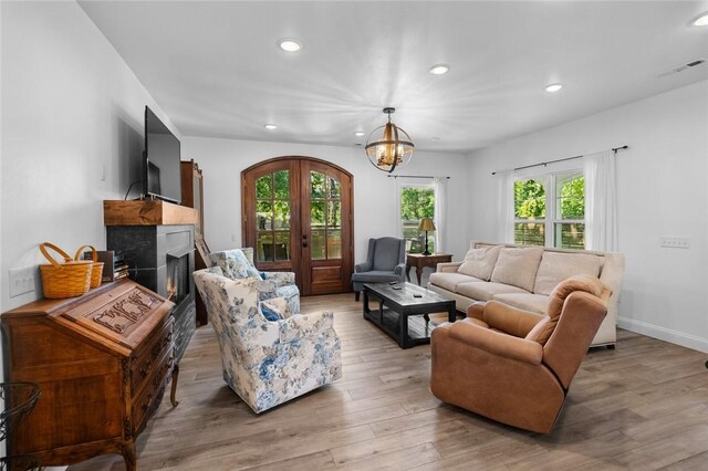 1330 S Curtis Ave, Pea Ridge, AR 72751 - living room featuring plenty of natural light, recessed lighting, a chandelier, light wood finished floors, and a warm lit fireplace