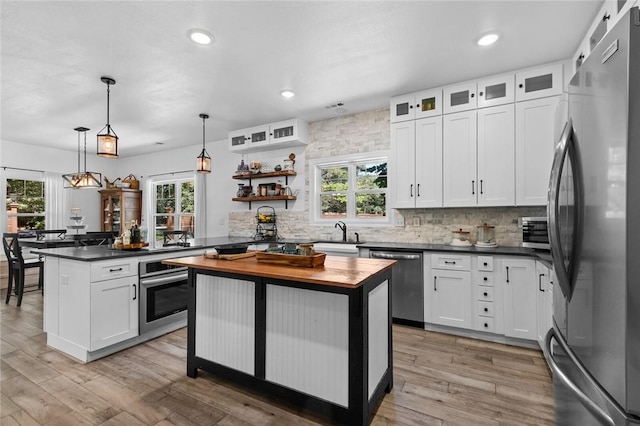 1330 S Curtis Ave, Pea Ridge, AR 72751 - kitchen featuring stainless steel appliances, butcher block counters, decorative backsplash, white cabinetry, and plenty of natural light