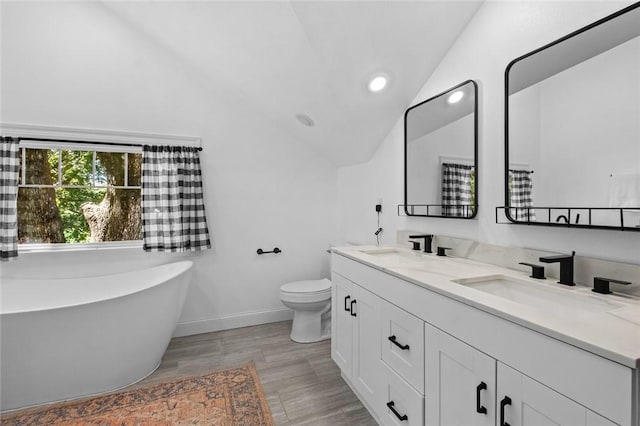 1330 S Curtis Ave, Pea Ridge, AR 72751 - bathroom with lofted ceiling, double vanity, a freestanding tub, recessed lighting, and wood finished floors