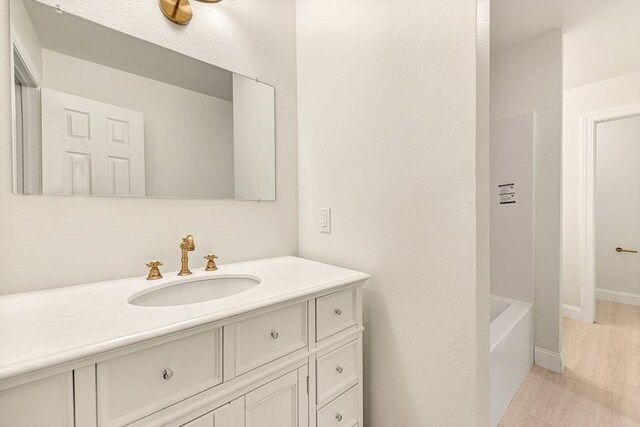 3917 E Caston Dr, Fayetteville, AR 72701 - full bath featuring vanity, wood finished floors, and a tub