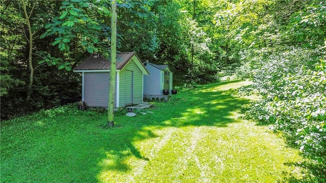8173 Spanker Creek Rd, Bentonville, AR 72712 - view of grassy yard with a storage unit