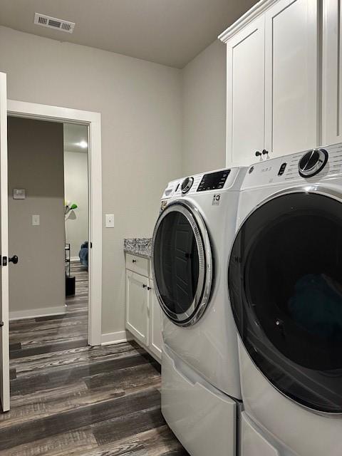 26 Osborne Dr, Bella Vista, AR 72715 - washroom featuring dark wood-type flooring, independent washer and dryer, and cabinet space
