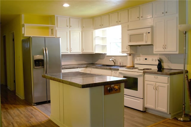 6 Hampstead Ln, Bella Vista, AR 72714 - kitchen with white appliances, dark countertops, white cabinetry, light wood finished floors, and recessed lighting