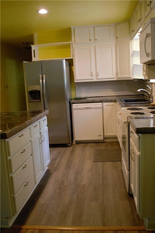 6 Hampstead Ln, Bella Vista, AR 72714 - kitchen featuring white appliances, dark countertops, white cabinets, and recessed lighting