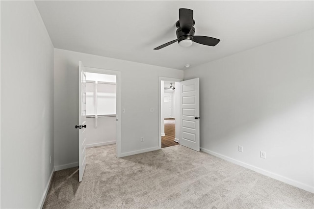 53 Belgravia Dr, Bella Vista, AR 72715 - unfurnished bedroom with a walk in closet, carpet flooring, a closet, and ceiling fan