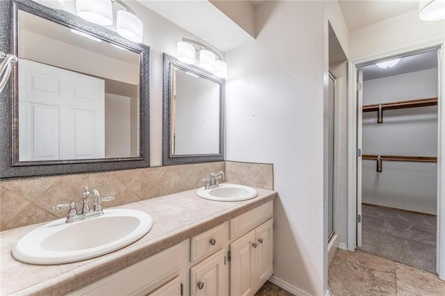 1206 Tru Ln, Rogers, AR 72756 - bathroom with double vanity, backsplash, a stall shower, and a spacious closet