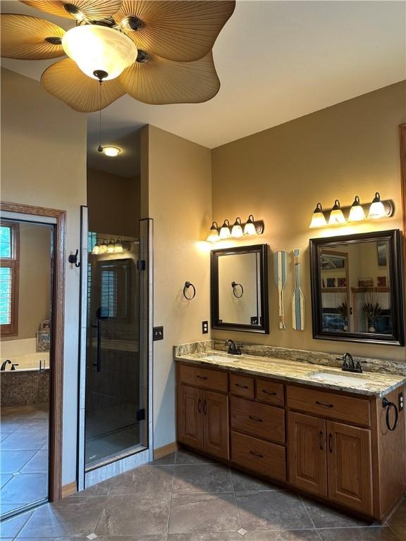 9364 Everest Pl, Rogers, AR 72756 - full bathroom featuring double vanity, a garden tub, a shower stall, and tile patterned flooring