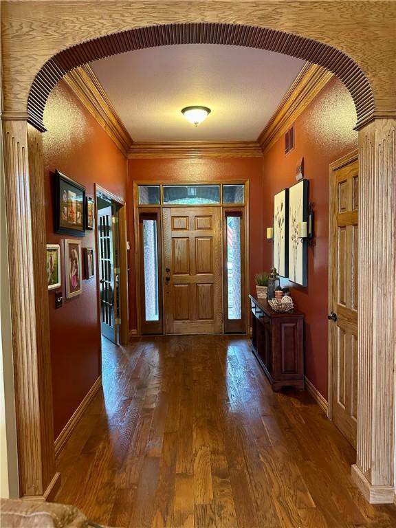 9364 Everest Pl, Rogers, AR 72756 - entryway featuring arched walkways, ornamental molding, and wood finished floors