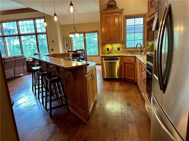 9364 Everest Pl, Rogers, AR 72756 - kitchen with stainless steel appliances, dark wood finished floors, light stone counters, and a breakfast bar area