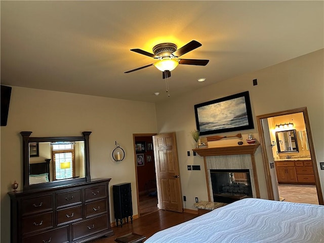 9364 Everest Pl, Rogers, AR 72756 - bedroom with a fireplace, wood finished floors, connected bathroom, and ceiling fan