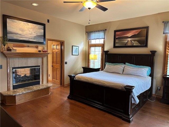 9364 Everest Pl, Rogers, AR 72756 - bedroom with wood finished floors, a tiled fireplace, a ceiling fan, and recessed lighting