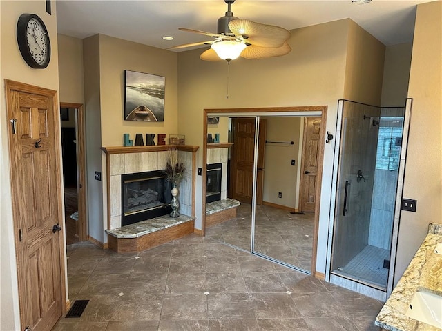 9364 Everest Pl, Rogers, AR 72756 - full bathroom featuring a fireplace, a shower stall, ceiling fan, and vanity