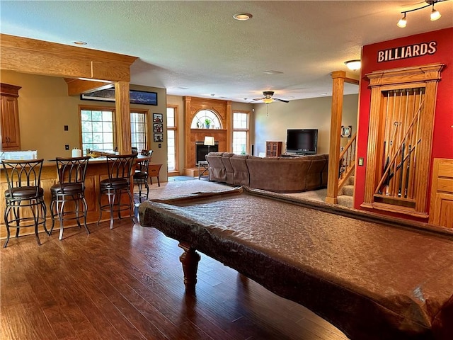 9364 Everest Pl, Rogers, AR 72756 - game room featuring ceiling fan, dark wood-style floors, healthy amount of natural light, a fireplace, and a textured ceiling