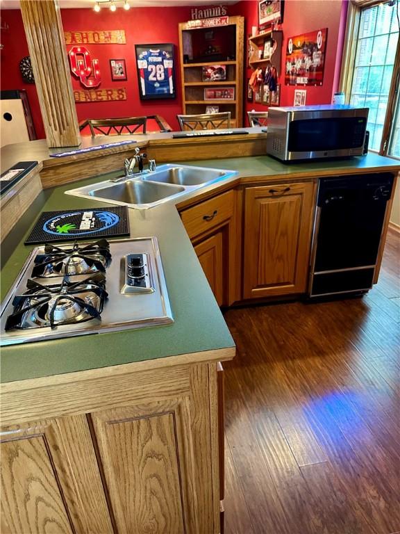 9364 Everest Pl, Rogers, AR 72756 - kitchen with stainless steel appliances, dark wood finished floors, brown cabinets, and light countertops