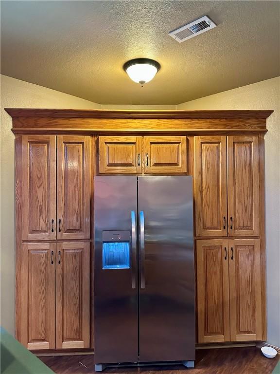 9364 Everest Pl, Rogers, AR 72756 - kitchen featuring stainless steel fridge, a textured ceiling, dark wood-type flooring, and brown cabinets