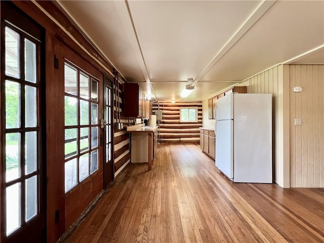 440 N Duff Ave, Sulphur Springs, AR 72768 - kitchen featuring freestanding refrigerator, hardwood / wood-style flooring, wooden walls, french doors, and a peninsula