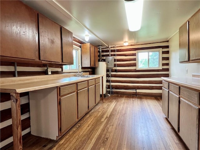 440 N Duff Ave, Sulphur Springs, AR 72768 - kitchen featuring hardwood / wood-style flooring, water heater, log walls, and plenty of natural light