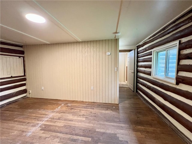 440 N Duff Ave, Sulphur Springs, AR 72768 - spare room with wood-type flooring and rustic walls