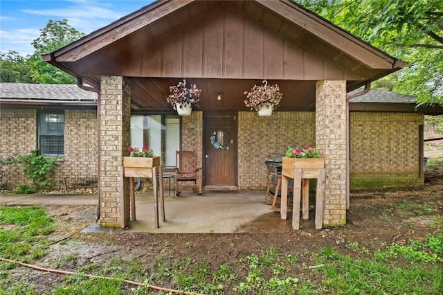 63155 S 4700, Watts, OK 74964 - view of exterior entry featuring brick siding and a shingled roof