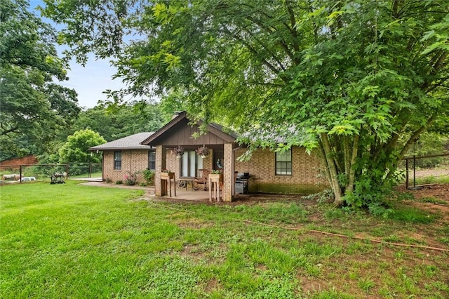 63155 S 4700, Watts, OK 74964 - rear view of property with a fenced backyard, brick siding, and a patio area