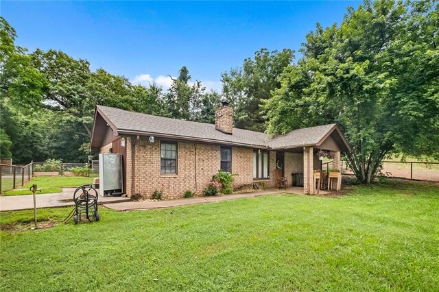 63155 S 4700, Watts, OK 74964 - view of front of home with a chimney, brick siding, a patio area, and a shingled roof