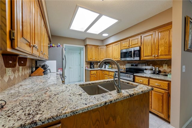2 Kildonan Ln, Bella Vista, AR 72715 - kitchen with appliances with stainless steel finishes, light stone counters, and tasteful backsplash
