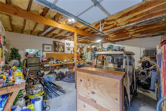 2 Kildonan Ln, Bella Vista, AR 72715 - garage featuring a workshop area and concrete block wall