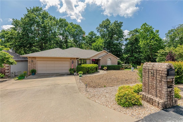 2 Kildonan Ln, Bella Vista, AR 72715 - ranch-style home with an attached garage, concrete driveway, and brick siding