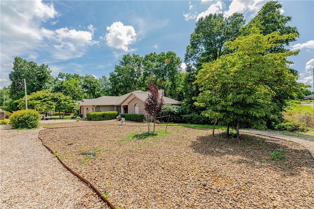 2 Kildonan Ln, Bella Vista, AR 72715 - view of front of house with view of wooded area and a chimney