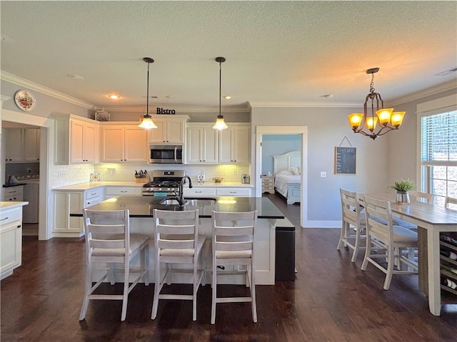 1610 Sweetbriar, Centerton, AR 72719 - kitchen featuring appliances with stainless steel finishes, a chandelier, crown molding, white cabinets, and backsplash