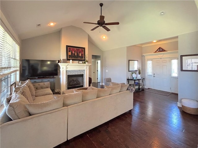 1610 Sweetbriar, Centerton, AR 72719 - living room featuring a fireplace, vaulted ceiling, dark wood-style floors, ceiling fan, and healthy amount of natural light