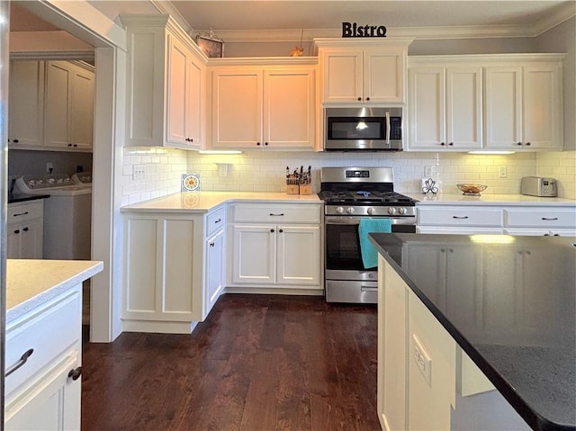 1610 Sweetbriar, Centerton, AR 72719 - kitchen with stainless steel appliances, washing machine and clothes dryer, crown molding, and white cabinets