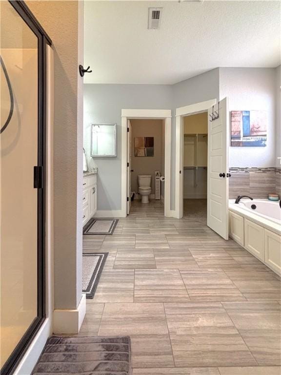 1610 Sweetbriar, Centerton, AR 72719 - full bath with a shower stall, a garden tub, vanity, and a closet
