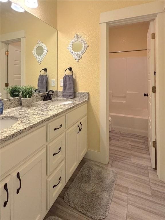 1610 Sweetbriar, Centerton, AR 72719 - bathroom with double vanity, a textured wall, shower / bath combination, and tile patterned flooring