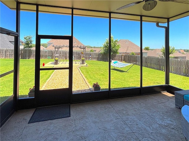 1610 Sweetbriar, Centerton, AR 72719 - unfurnished sunroom with a residential view, ceiling fan, and healthy amount of natural light
