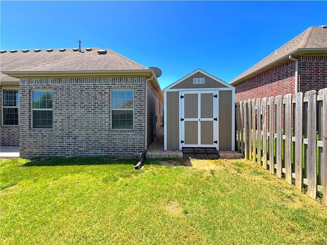 1610 Sweetbriar, Centerton, AR 72719 - rear view of house with a storage unit, brick siding, and a fenced backyard