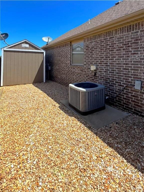 1610 Sweetbriar, Centerton, AR 72719 - view of side of property featuring a storage shed and brick siding