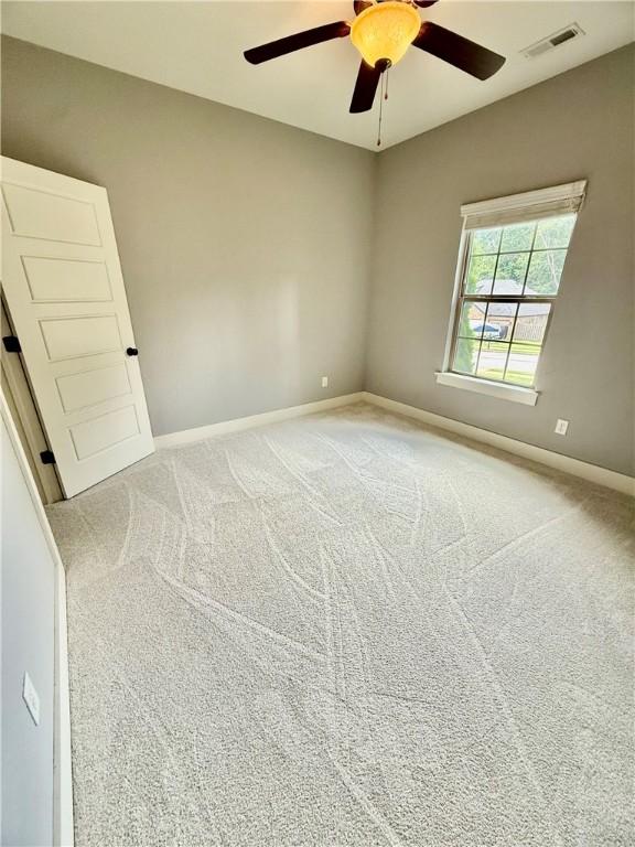 1610 Sweetbriar, Centerton, AR 72719 - carpeted empty room with ceiling fan and baseboards