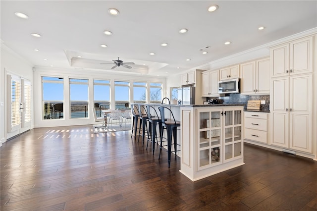 40 Rivercliff Rd, Rogers, AR 72756 - kitchen featuring stainless steel appliances, ornamental molding, dark countertops, dark wood-style flooring, and plenty of natural light