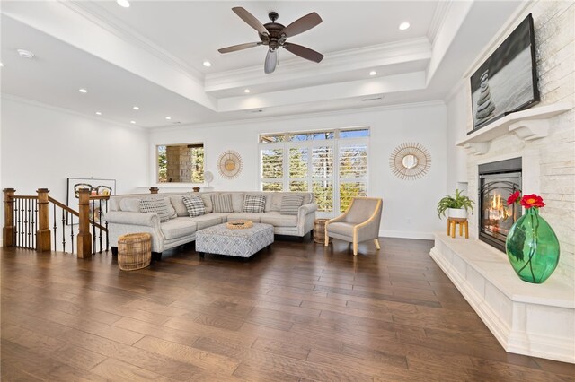 40 Rivercliff Rd, Rogers, AR 72756 - living room featuring wood-type flooring, a glass covered fireplace, a tray ceiling, ceiling fan, and recessed lighting