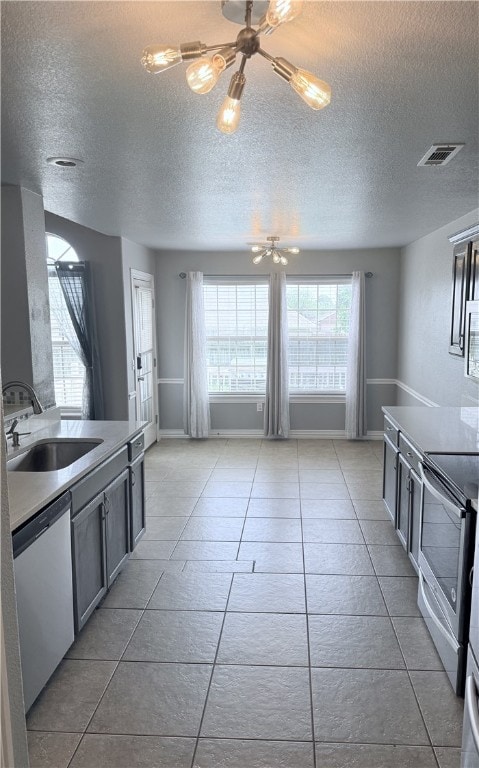 1204 Jim Mcvay, Siloam Springs, AR 72761 - kitchen with stainless steel appliances, a textured ceiling, and light tile patterned floors