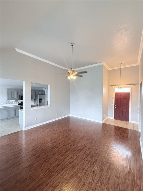 1204 Jim Mcvay, Siloam Springs, AR 72761 - unfurnished living room featuring light wood-style flooring, ornamental molding, a ceiling fan, and a towering ceiling