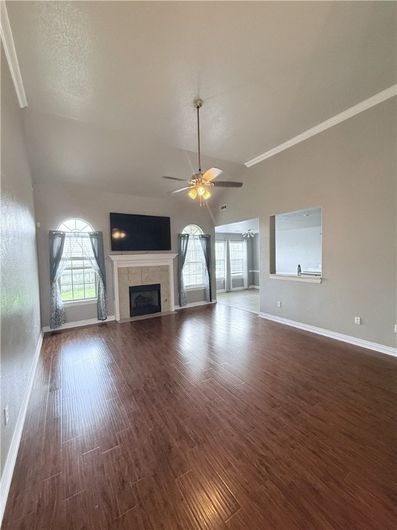 1204 Jim Mcvay, Siloam Springs, AR 72761 - unfurnished living room with ceiling fan, a fireplace, dark wood-style floors, vaulted ceiling, and crown molding